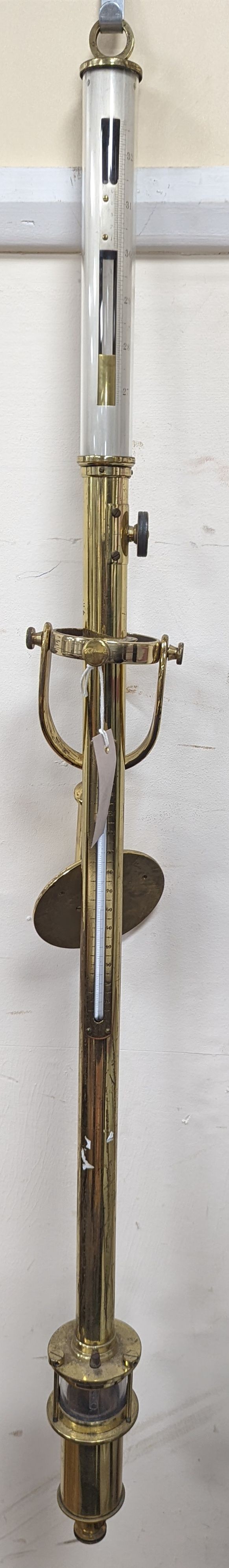 A brass ship's barometer and thermometer with gimbled wall mount, height 100cm